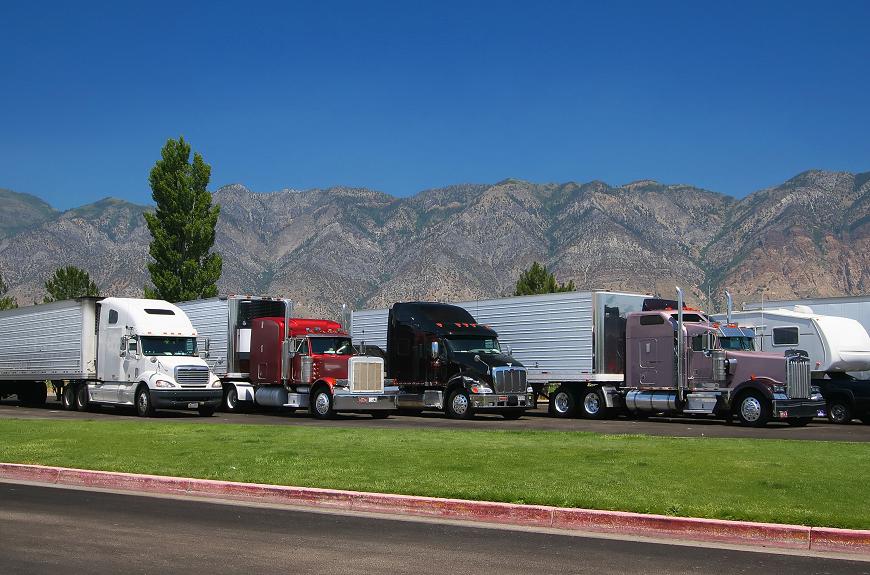 Semi trucks in a row parked, showcasing durability and comfort for truck mattress and sheet sets.